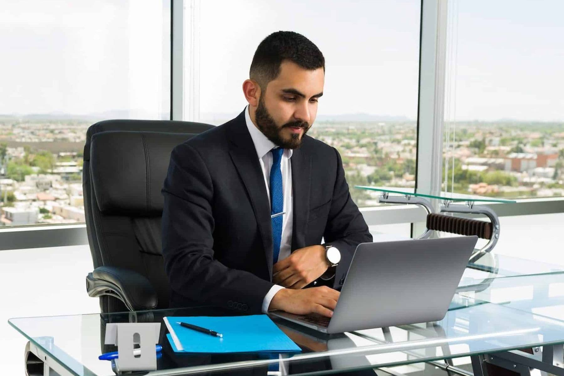 Finance professional using a laptop in a modern office to review ERP systems and UAE VAT compliance data.