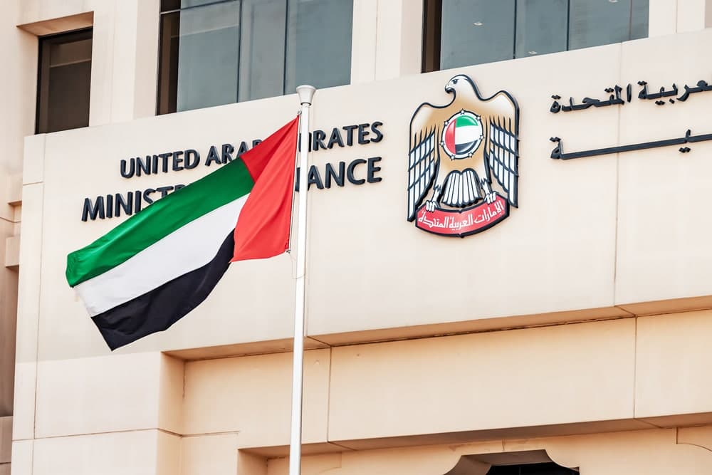 23 February 2021, Dubai, UAE: coat of arms and flag at the Ministry of Finance of the United Arab Emirates in Dubai, which is part of the Cabinet of Ministers, is located in the Creek district.