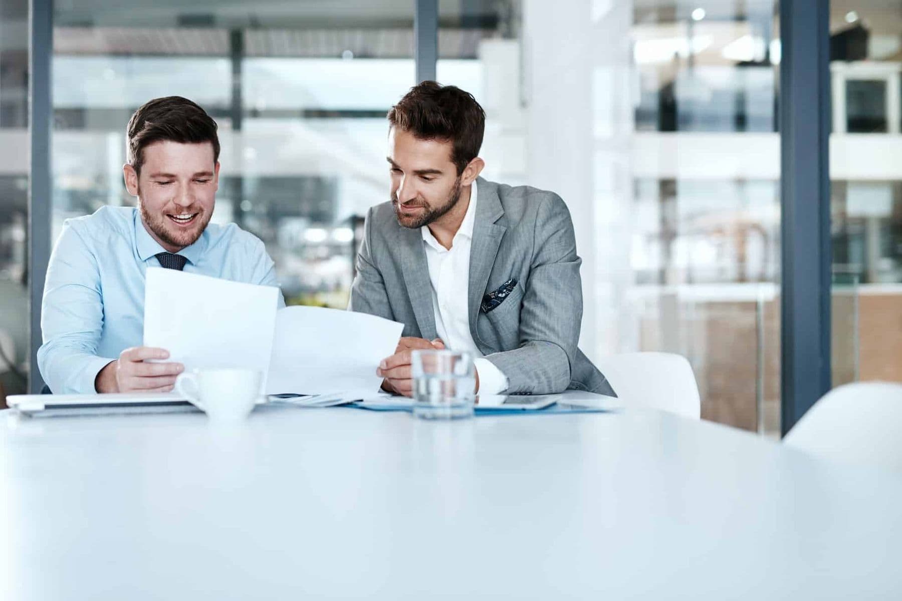 A well-dressed tax agent helping a client with their tax residency certificate in the UAE.