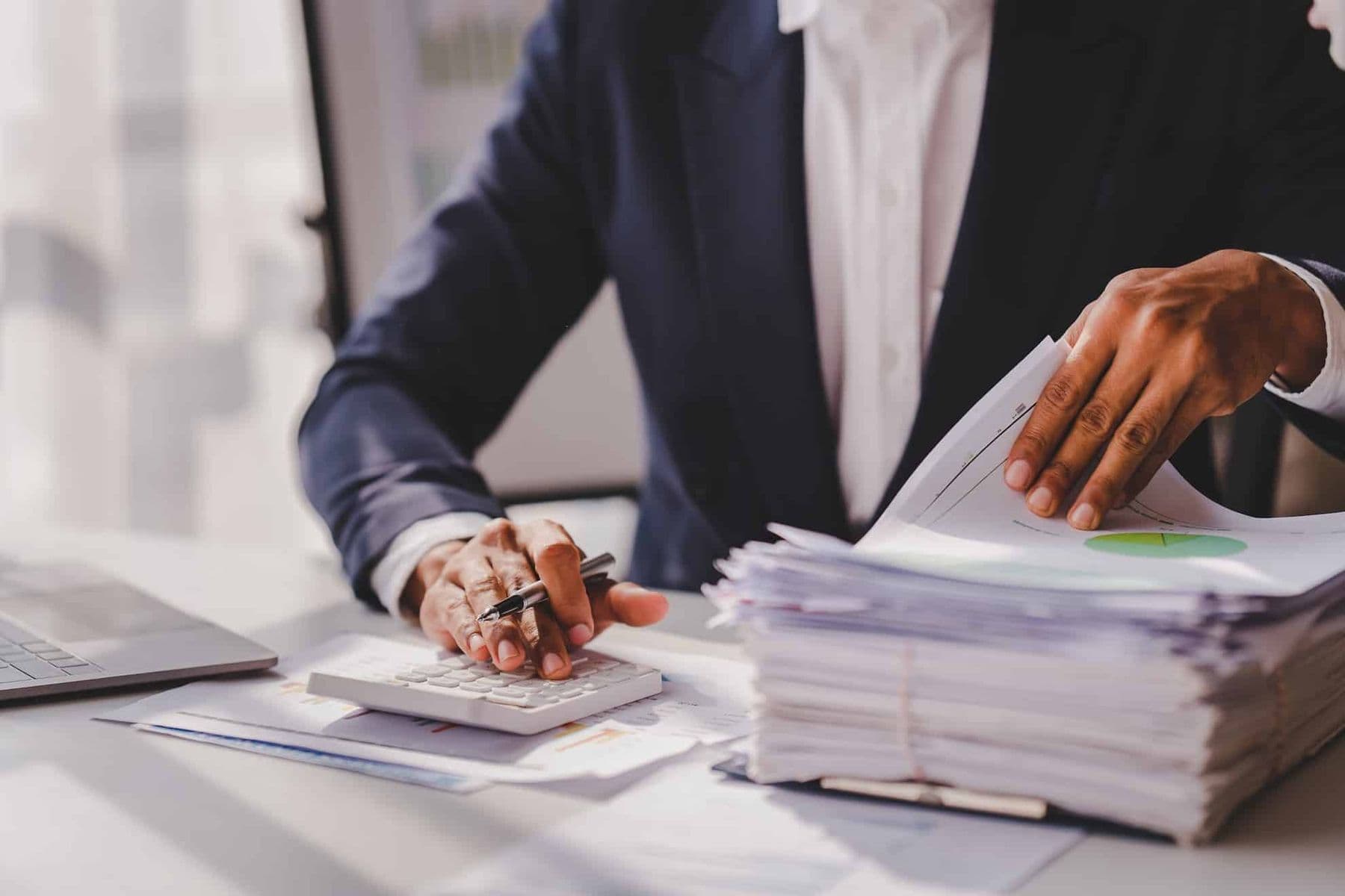 TaxReady business professional reviewing VAT documents and calculating tax compliance in their UAE office.