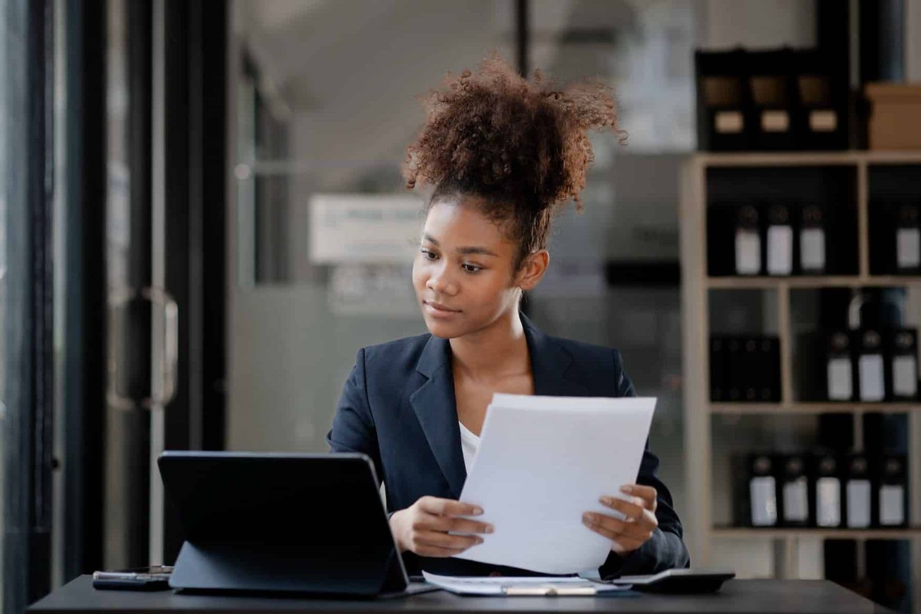 Business professional reviewing supplier documents on a laptop as part of TRN verification and VAT compliance in the UAE.