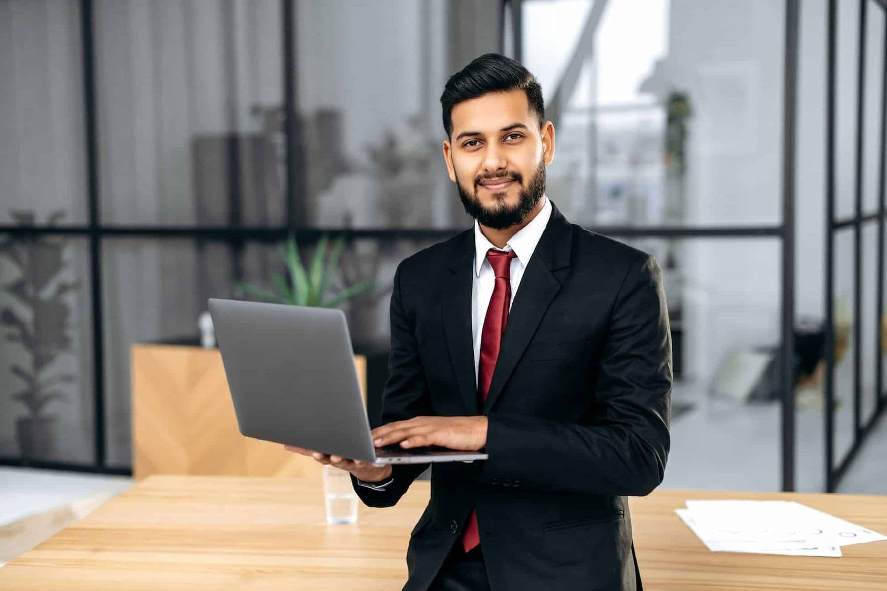 A professional tax agent in a suit with a laptop, ready to file his clients VAT return in the UAE.