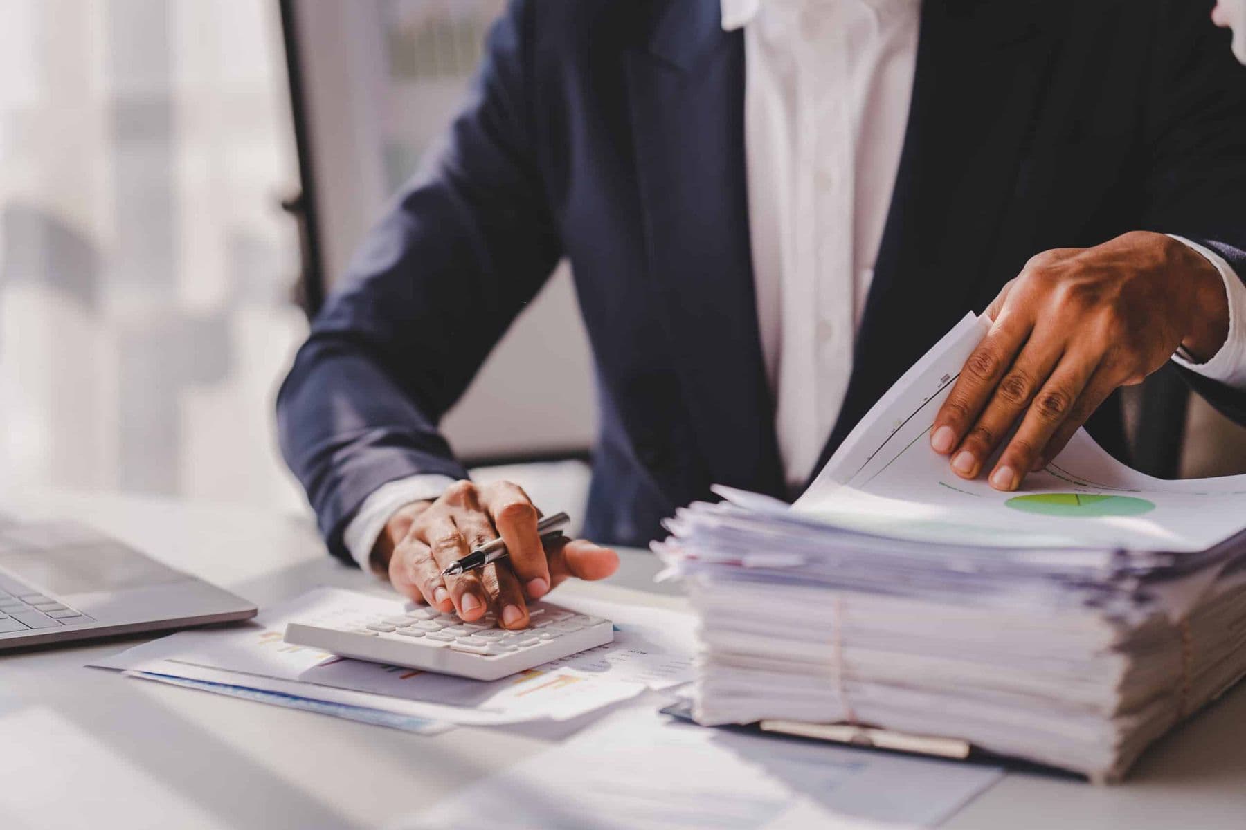 Accountant reviewing company expense records and calculator for non-deductible expenses under UAE corporate tax.